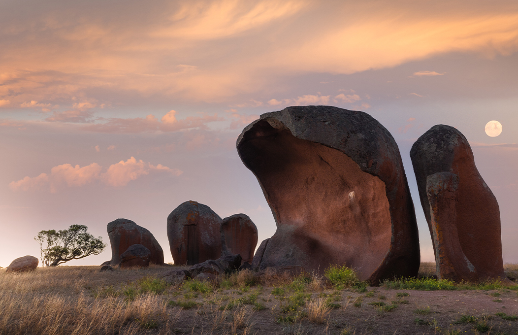 The rock formations of Murphy's Haystack standing tall as the moon rises above.